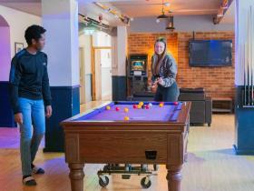 Students playing pool in the LMH Bar