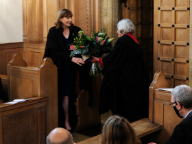Professor Christine Gerrard being handed flowers in the LMH Chapel at the Principal's Inauguration