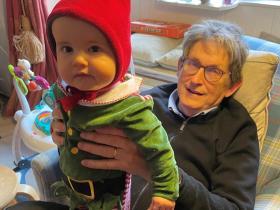 Photo of Alan Rusbridger sitting in a chair with his grandson