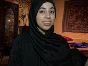 Photo of Aneela Shah, who wears a black hijab