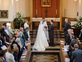 A man and a woman being married in the LMH Chapel