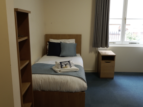 Picture of Graduate room at LMH showing a bed and a window