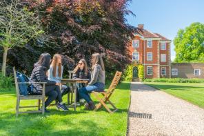 LMH students sitting at a table chatting in LMH grounds