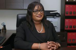 Dr Alicia Elias-Roberts sitting at her desk in her office at the University of the West Indies, St Augustine Campus