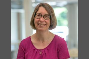 Photo of Christina Goldschmidt smiling at the camera and wearing a pink top