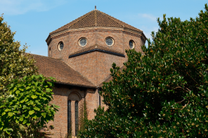 The exterior of the LMH Chapel building, with a round tower against a blue sky