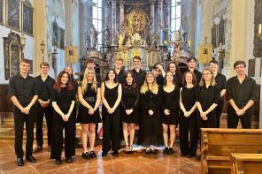 A photo of a group of LMH students dressed in black standing in a chapel in Austria