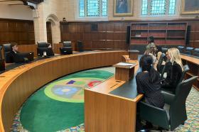 Photo of students sitting at desks at the UK High Court