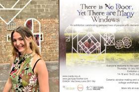 Georgia Crowther, a white woman with long light brown hair, standing in an art gallery