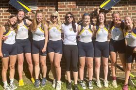 A group of students standing outside the LMH boathouse