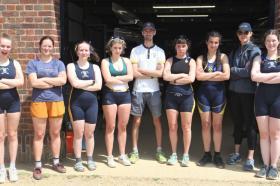 A group of students standing outside the LMH boathouse