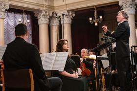 Conductor Pawel Kotla stands in the National Philharmonic of Ukraine in Kyiv conducting a special 'Concert for Freedom'