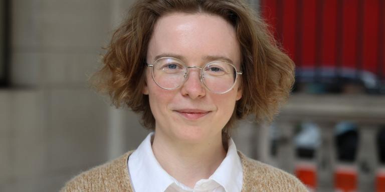 Marlene Danner, a woman with short curly hair and glasses, smiles at the camera