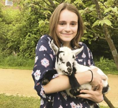 Photo of Cara Nichsolson holding a lamb