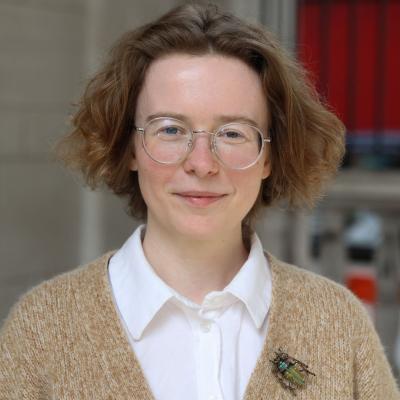 Marlene Danner, a woman with short curly hair and glasses, smiles at the camera