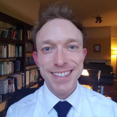 Dr Ben Higgins, who is wearing a white shirt and dark tie
