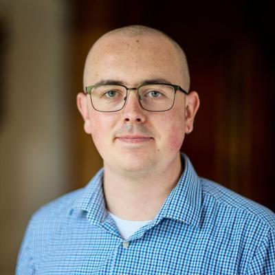 Samuel Johnson, a man wearing glasses and a blue shirt