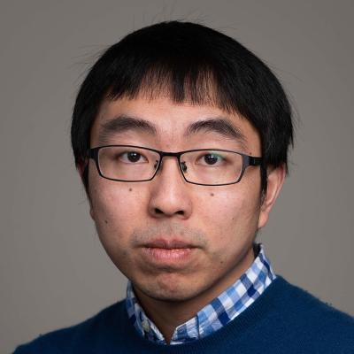 Portrait photo of Dr Xiaowen Dong, who has short dark hair and glasses