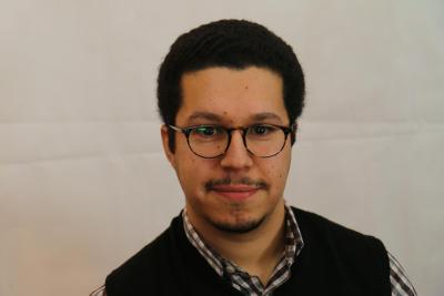 Photo of a man with short dark hair and glasses