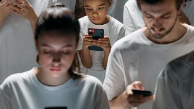 A group of people looking at phone