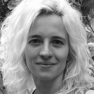 A black and white portrait photo of a woman with bleached blonde wavy hair